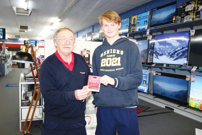 AFL tipping champ giving prize to mum