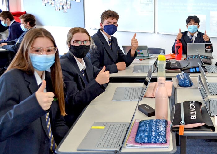 Masked-up students back in class