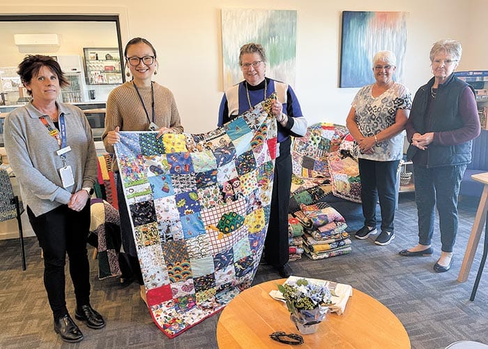 Crafting quilts to care for locals in need